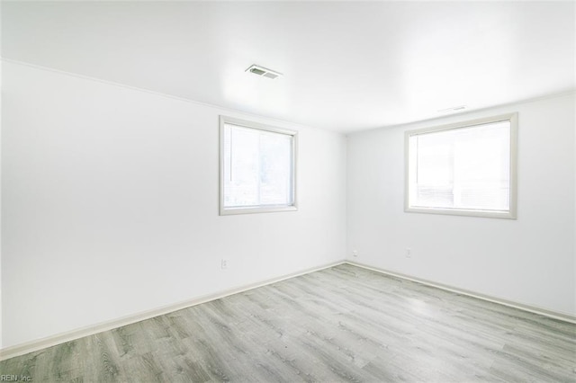 spare room featuring light hardwood / wood-style floors