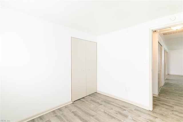 unfurnished room with light wood-type flooring