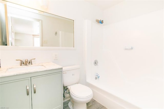 full bathroom featuring washtub / shower combination, vanity, and toilet