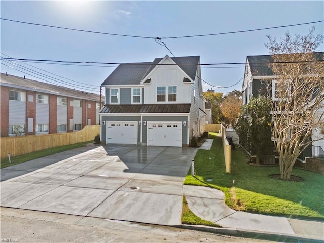 view of front of property featuring a front yard and a garage