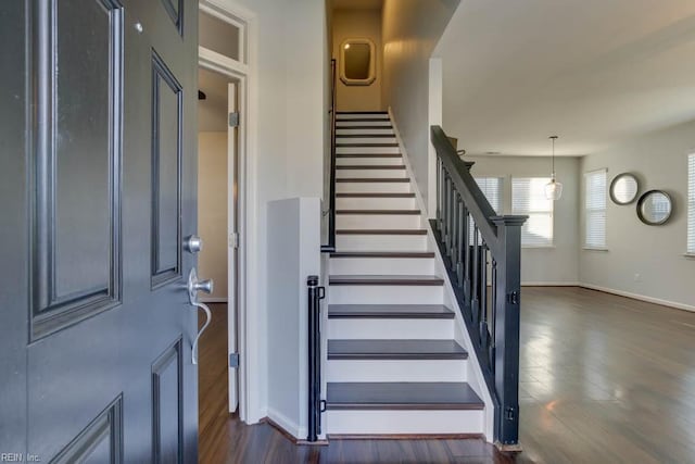 stairs featuring hardwood / wood-style floors