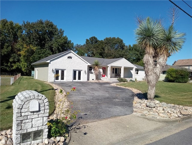 ranch-style house with french doors and a front lawn