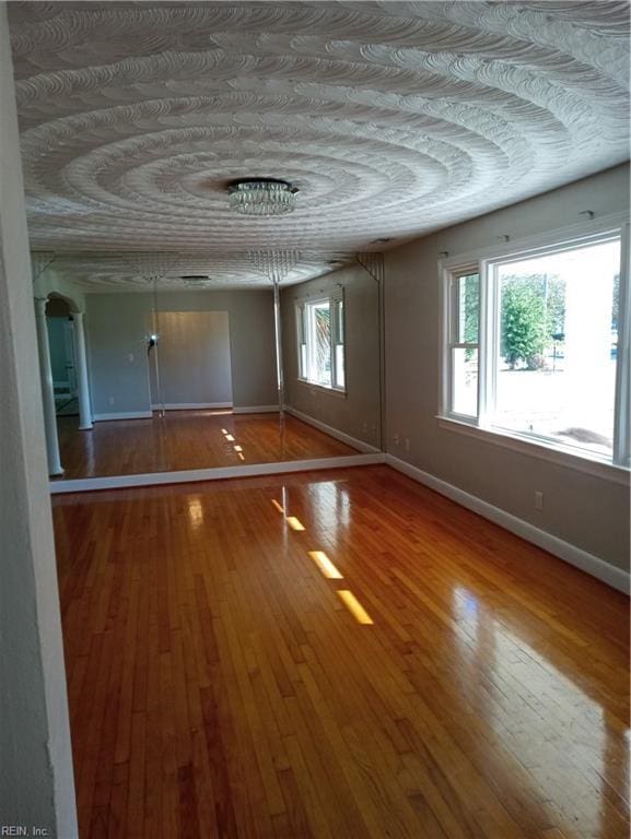 unfurnished room with hardwood / wood-style floors