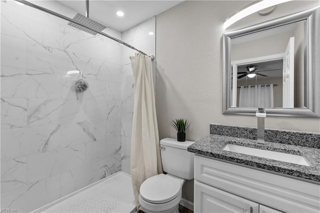 bathroom with vanity, ceiling fan, toilet, and walk in shower