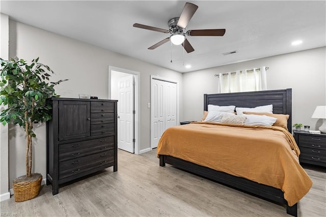 bedroom featuring light wood-type flooring, a closet, and ceiling fan