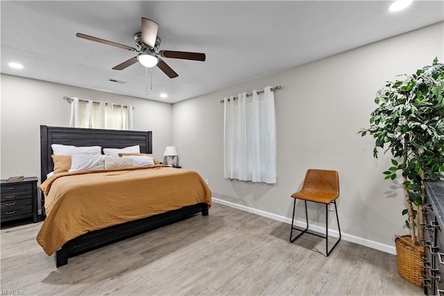 bedroom with ceiling fan and hardwood / wood-style flooring