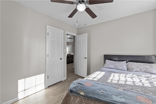 bedroom with hardwood / wood-style flooring and ceiling fan