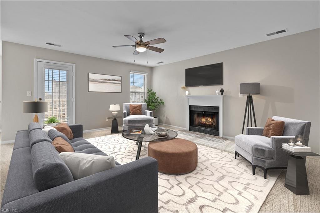 carpeted living room with plenty of natural light and ceiling fan