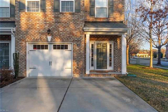 view of front of home with a front yard and a garage