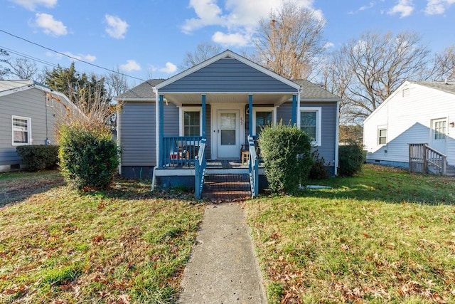 bungalow with a front yard and a porch