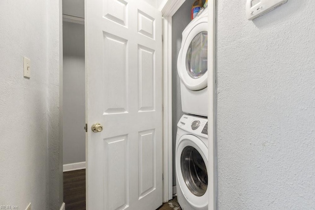 clothes washing area with stacked washer / drying machine