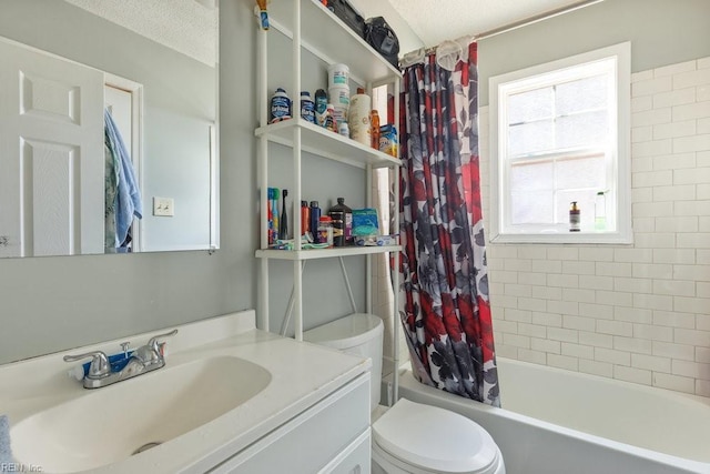 full bathroom featuring a textured ceiling, vanity, shower / bath combo, and toilet