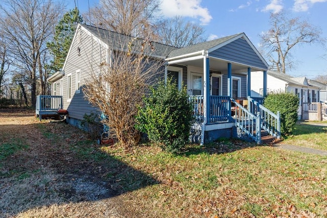 view of front of home featuring covered porch and a front yard