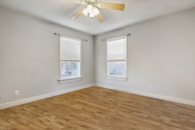 empty room featuring ceiling fan, wood-type flooring, and a textured ceiling