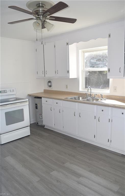 kitchen with electric range, sink, ceiling fan, dark wood-type flooring, and white cabinets