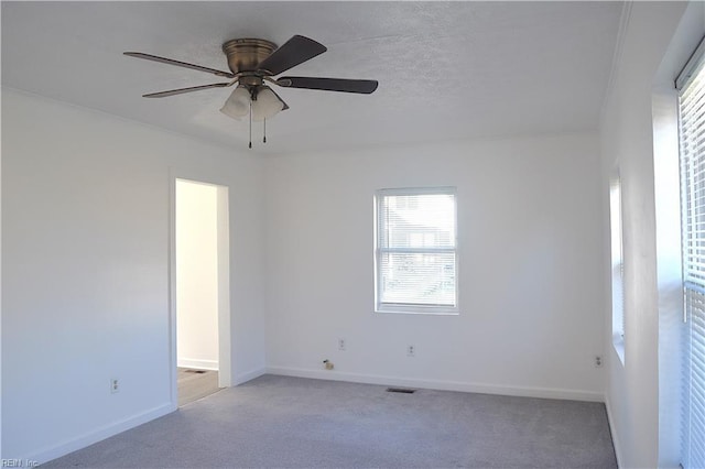 unfurnished room with light carpet and ceiling fan