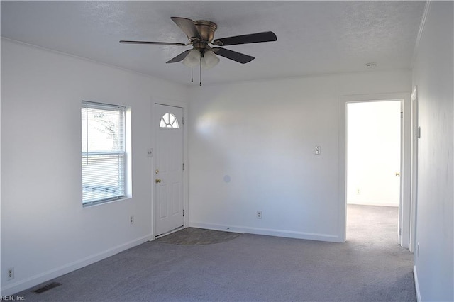 entrance foyer with carpet flooring and ceiling fan