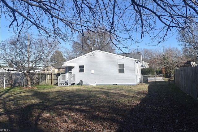 back of house with a lawn