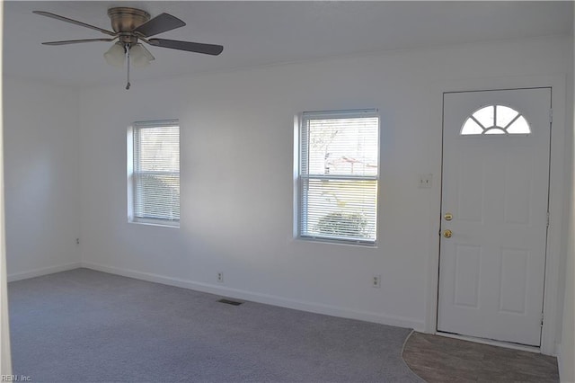 entrance foyer with carpet and ceiling fan