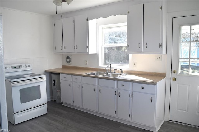 kitchen with electric range, sink, white cabinets, and dark hardwood / wood-style floors