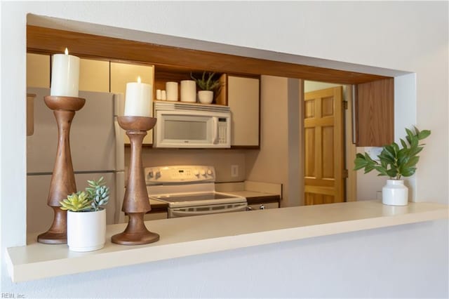 kitchen with open shelves, white appliances, and light countertops