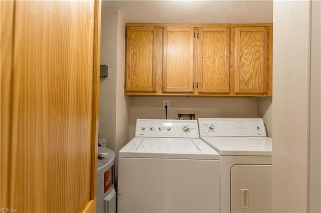 washroom with washer and dryer and cabinet space