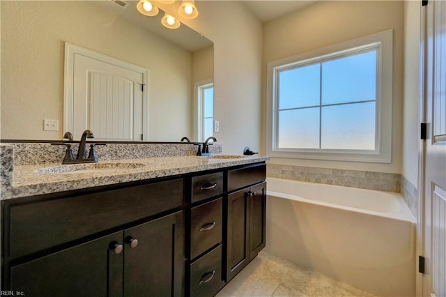 bathroom featuring a bath, vanity, and tile patterned floors