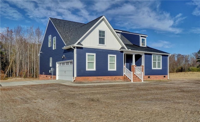 view of front of property with covered porch and a garage