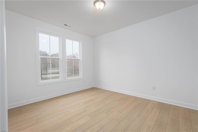 unfurnished room with light wood-type flooring