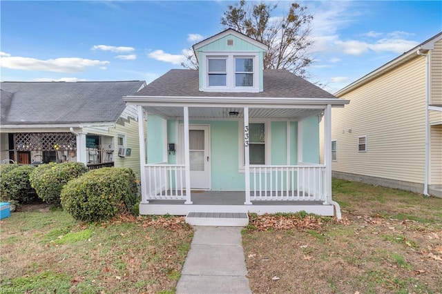 bungalow-style house with cooling unit and covered porch