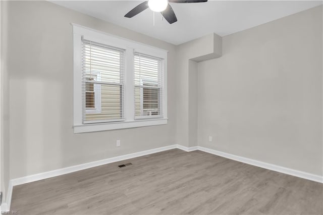 spare room with ceiling fan and hardwood / wood-style flooring