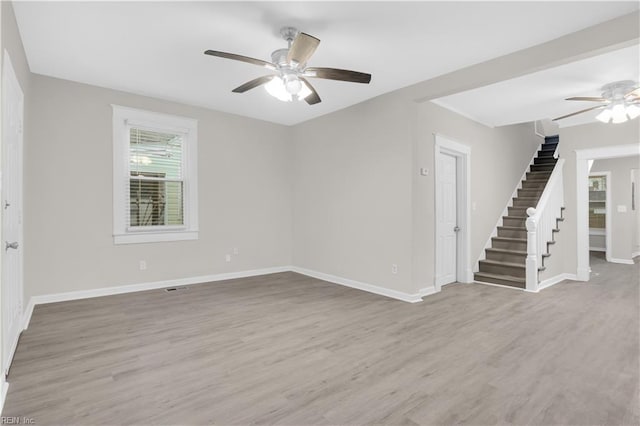 empty room featuring light wood-type flooring and ceiling fan