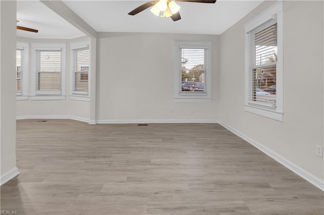 empty room featuring ceiling fan and light hardwood / wood-style flooring