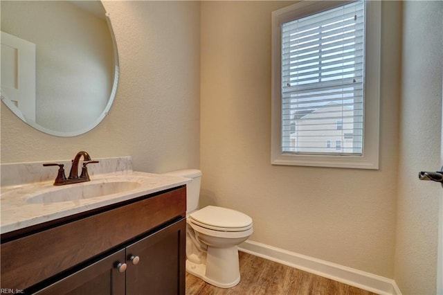 bathroom featuring hardwood / wood-style floors, vanity, and toilet