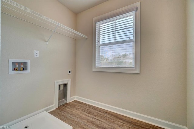 clothes washing area with hardwood / wood-style flooring, electric dryer hookup, and hookup for a washing machine