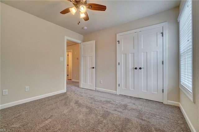 unfurnished bedroom with carpet floors, a closet, and ceiling fan