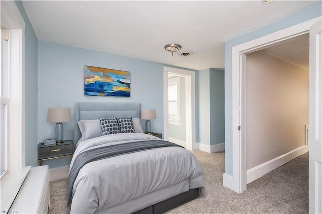 bedroom with light colored carpet