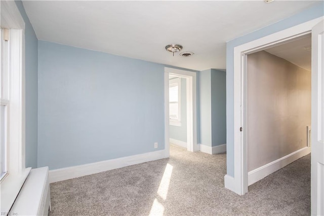 unfurnished room with light carpet