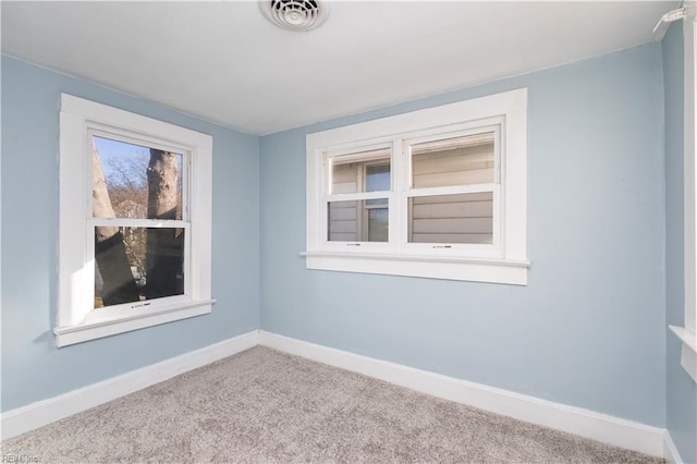 spare room featuring light colored carpet