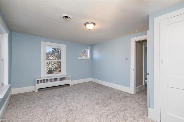 carpeted spare room with radiator