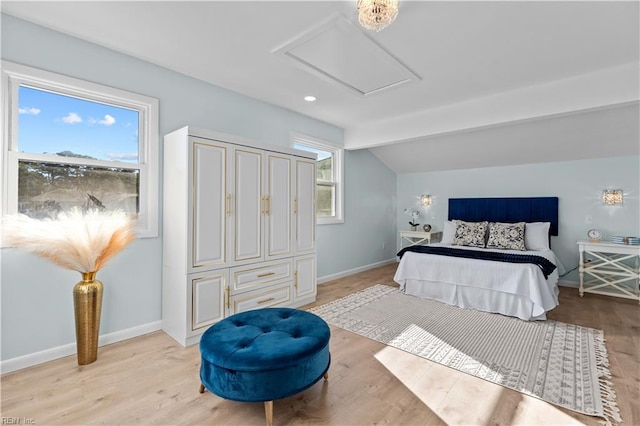 bedroom featuring light wood-type flooring and vaulted ceiling