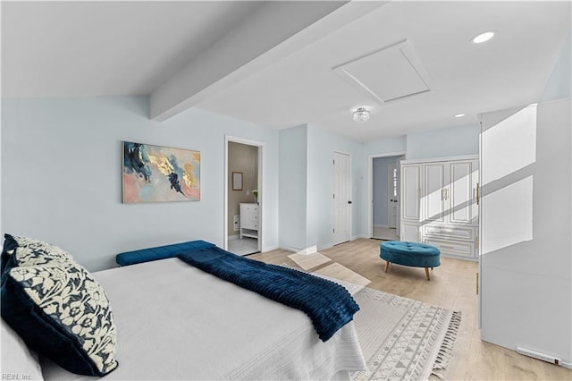 bedroom with beamed ceiling and light hardwood / wood-style flooring