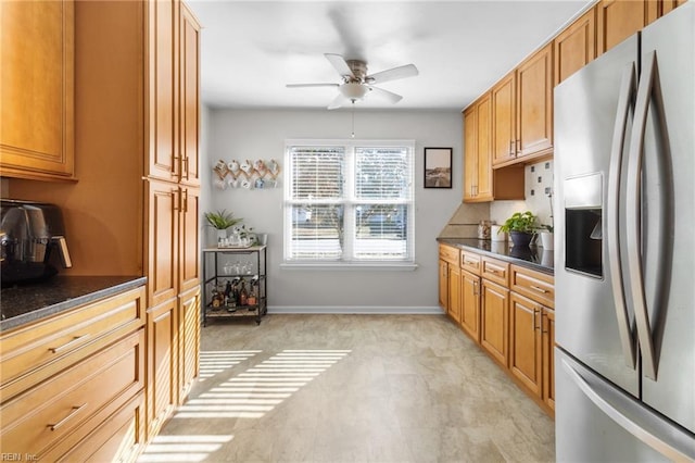 kitchen with stainless steel refrigerator with ice dispenser and ceiling fan