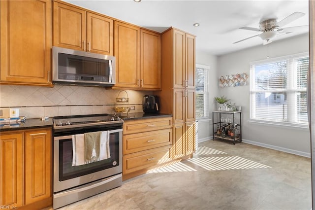 kitchen featuring stainless steel appliances, tasteful backsplash, and ceiling fan