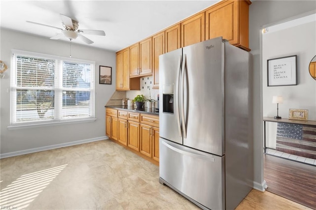 kitchen featuring stainless steel fridge, backsplash, and ceiling fan