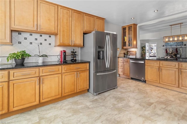 kitchen featuring pendant lighting, stainless steel appliances, dark stone countertops, and sink