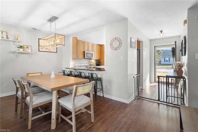 dining space with dark hardwood / wood-style floors