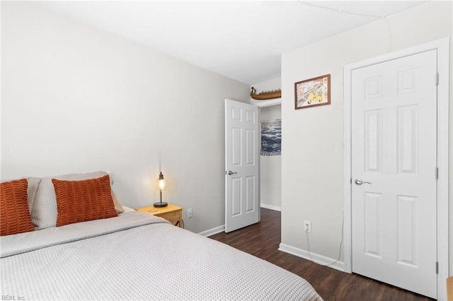 bedroom with dark hardwood / wood-style flooring