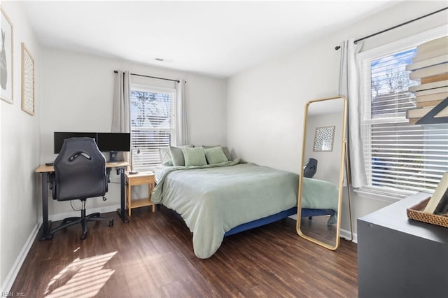 bedroom with dark hardwood / wood-style floors