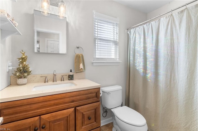 bathroom featuring walk in shower, vanity, and toilet